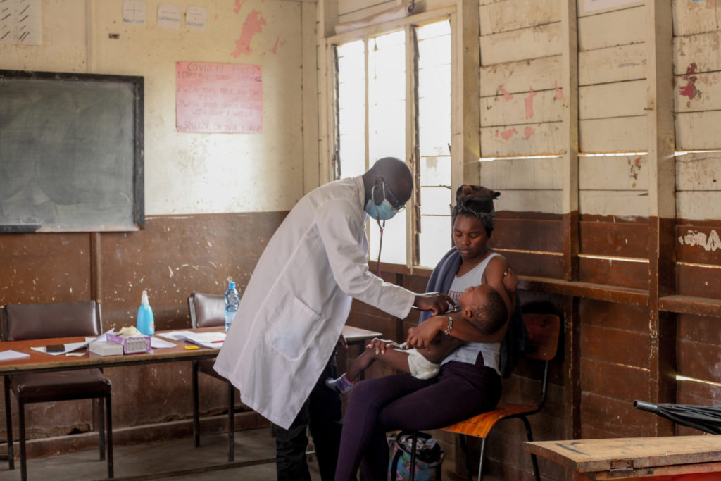 An image of a doctor attending to a child with a disability